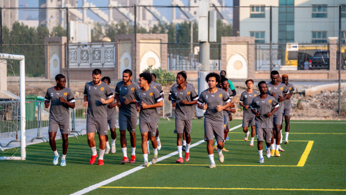 Football players warming up on the training pitch at the Dubai Football Showcase