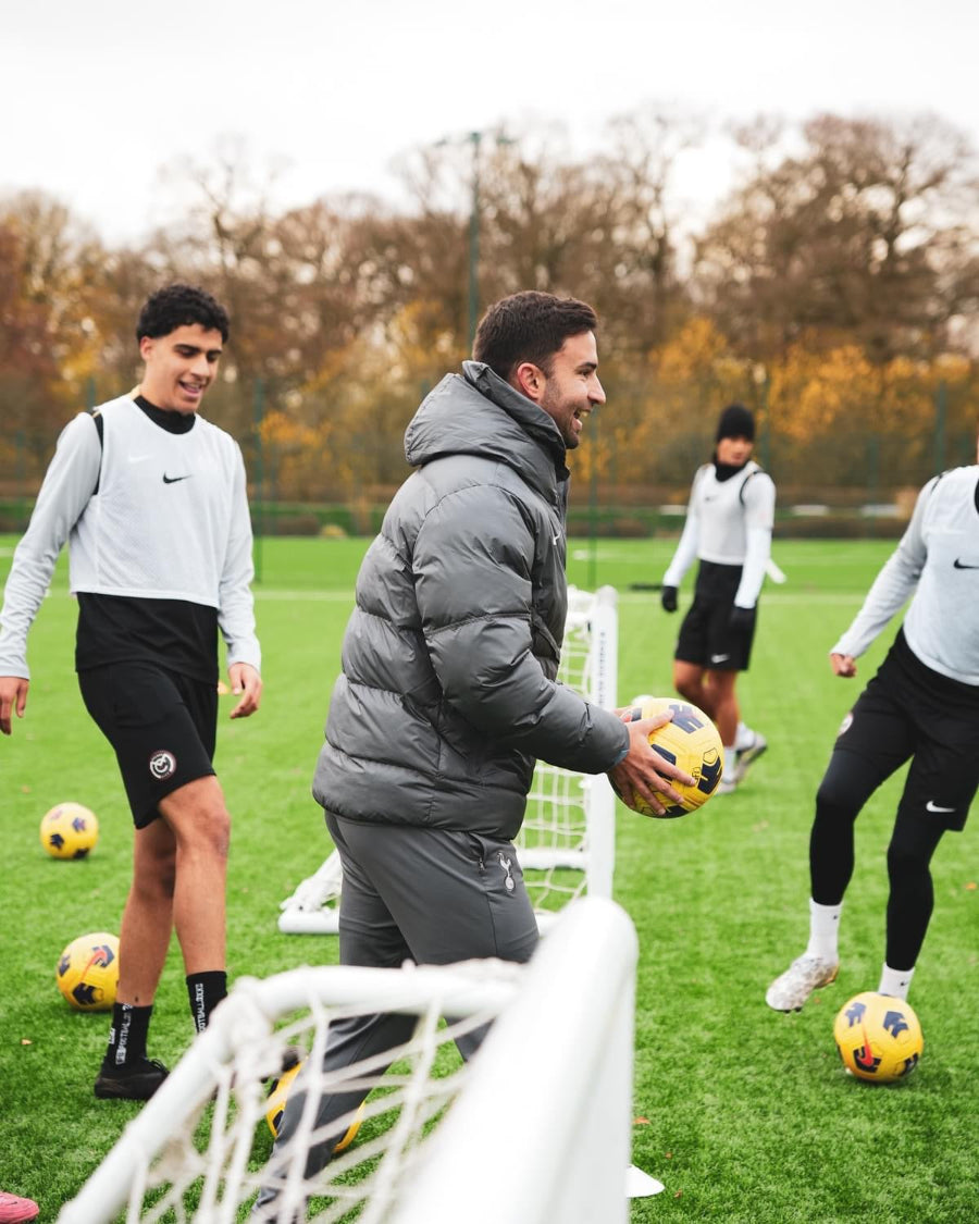 A coach working with players at a training session